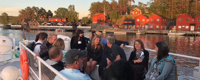 Participants socializing during an evening boat ride in Sweden.