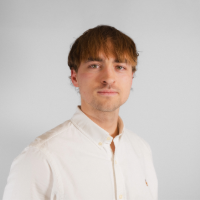 Headshot of Nikolai Holm Elkj&aelig;r Rasmussen in a white shirt against a plain grey background.