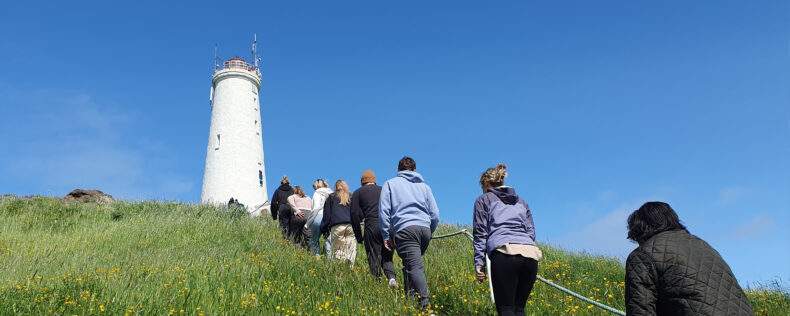 Students walking up a hill in Iceland during a nice summer day.