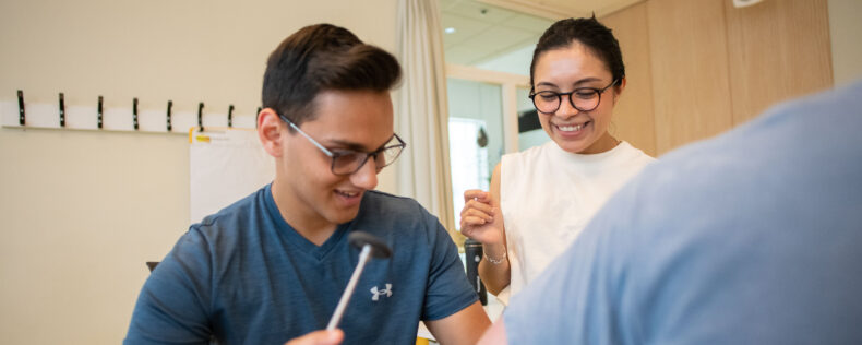 Student & professor laughing during a Biomedical lab.