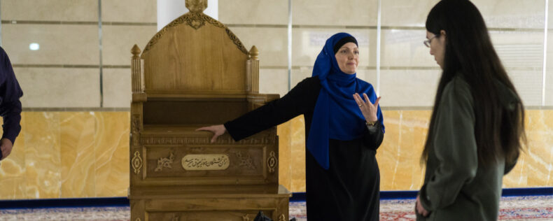 Muslim woman giving a tour to students in a Mosque.