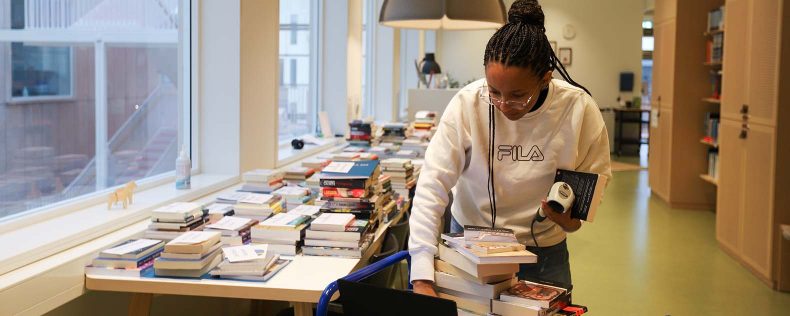 Phaedra organizing books in the hub